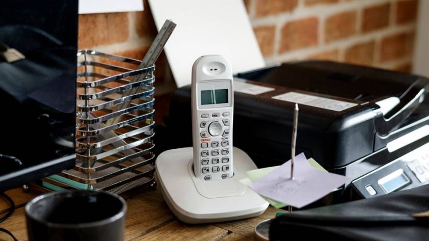 A VoIP phone adapter, connected to a telephone and internet source.