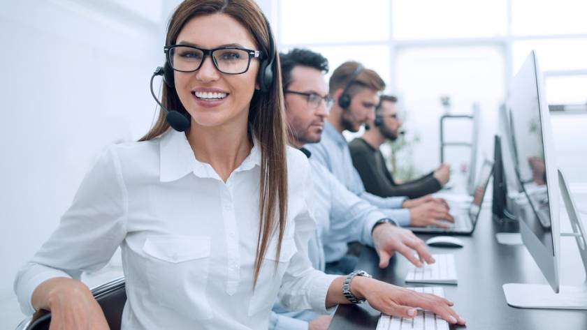 A bustling contact center with agents assisting customers via phone, email, and chat, representing the heart of customer service