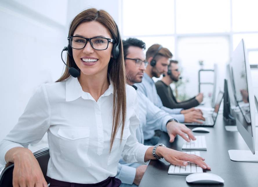 A bustling contact center with agents assisting customers via phone, email, and chat, representing the heart of customer service