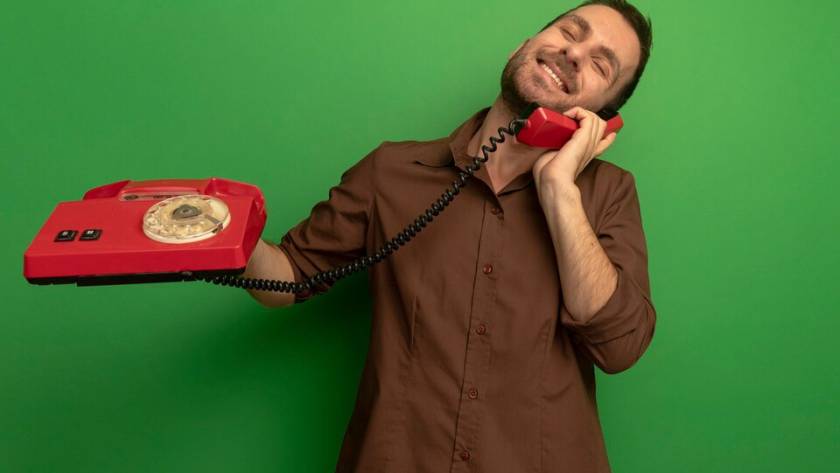 A landline phone symbolically redirecting a call to a mobile device, representing the process of landline call diversion